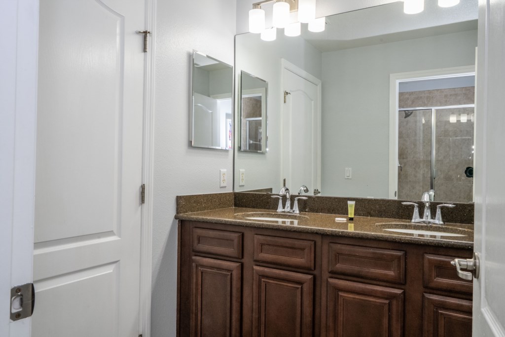 Shared bathroom w/ walk in shower and double sinks