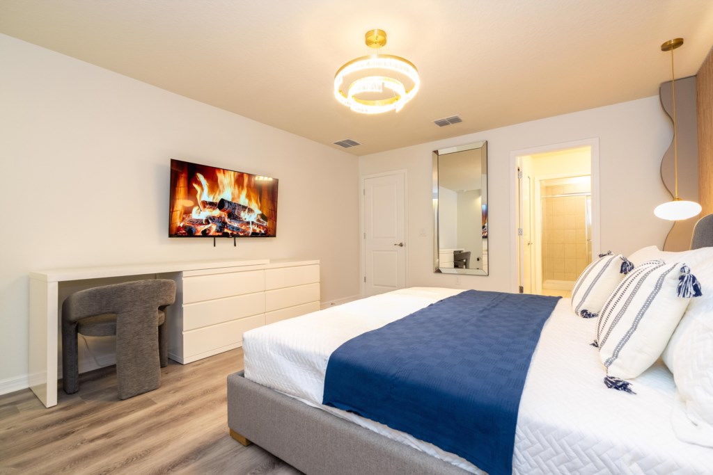 Master suite w/ king size bed, TV, work area and private bathroom