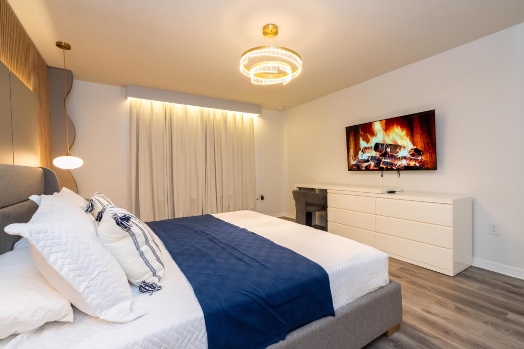 Master suite w/ king size bed, TV, work area and private bathroom
