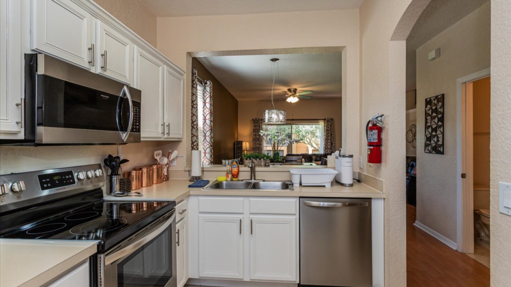 Kitchen
Spacious kitchen with double sink, dishwasher, and open pass-through window overlooking the dinning area.