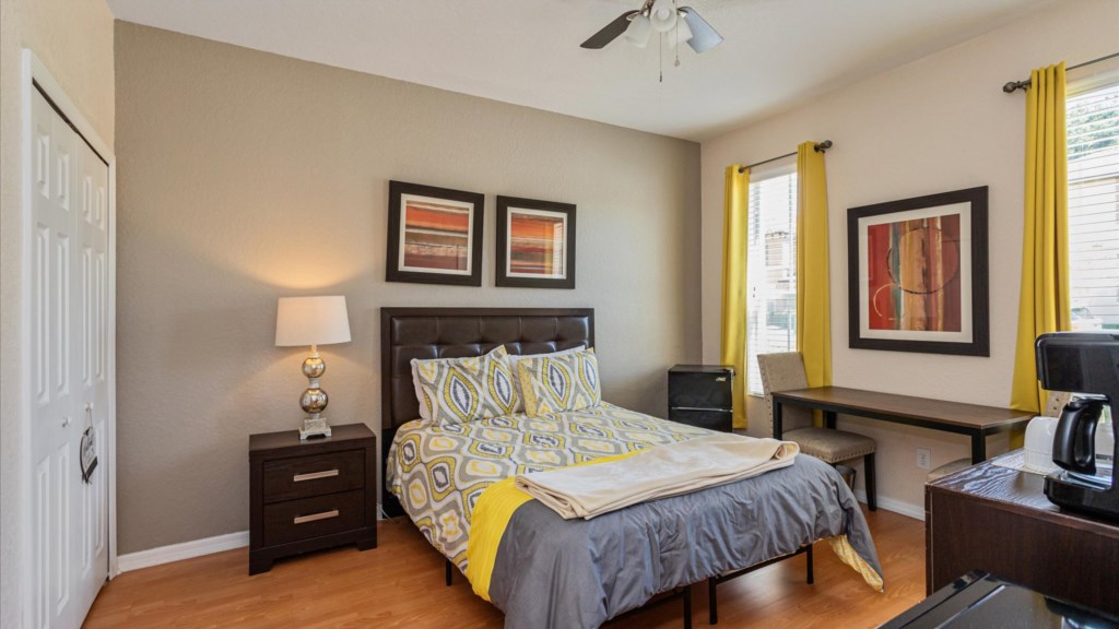 In Law suite
Cozy guest bedroom with a queen bed, cheerful yellow curtains, TV, and a coffee station f