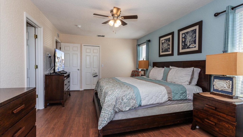 Master Bedroom
Spacious master suite with a king bed, tasteful ocean-inspired décor, TV, and private balcony access.