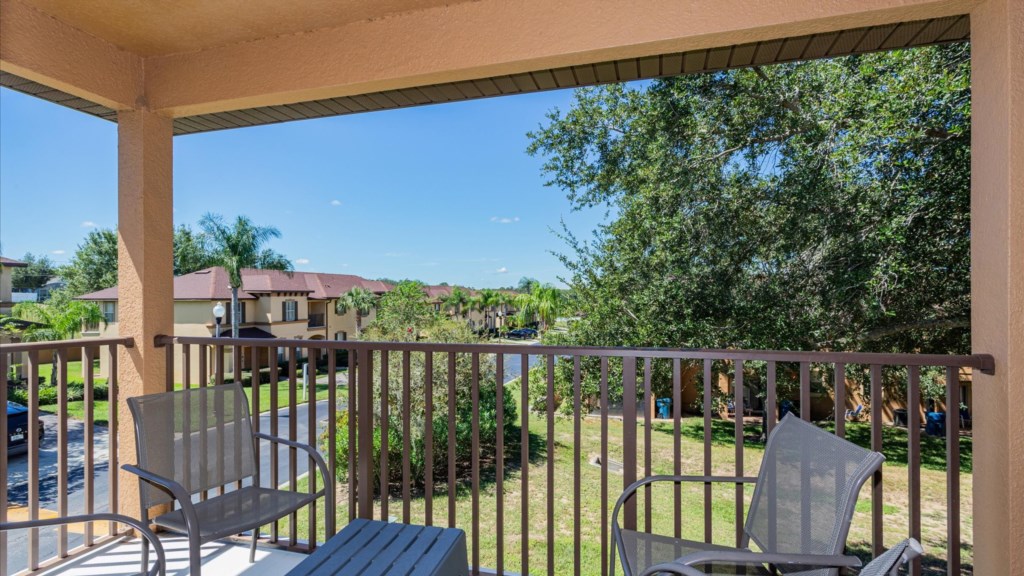 Private Balcony
Covered balcony with outdoor seating overlooking the resort community and lush greenery,an ideal spot.
