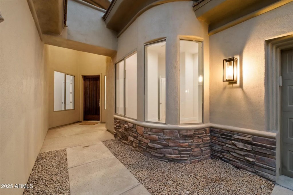 Welcoming entryway with warm lighting and elegant stone accents.