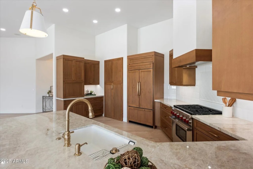 Modern kitchen with high-end appliances and elegant marble countertops.