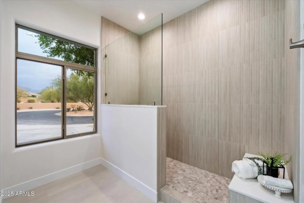 Modern bathroom with spacious walk-in shower and serene desert views.