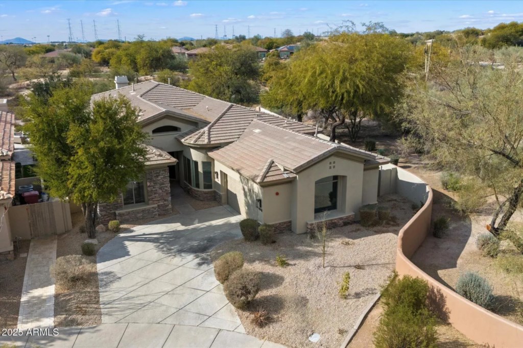 Spacious desert home with scenic surroundings and ample driveway parking.