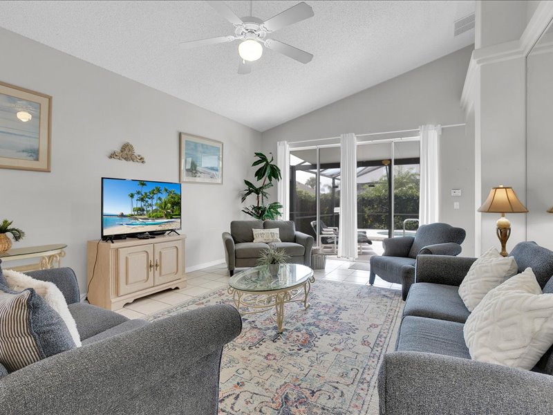 Living room w/ couches, chair & flat screen TV