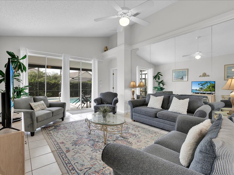 Living room w/ couches, chair & flat screen TV