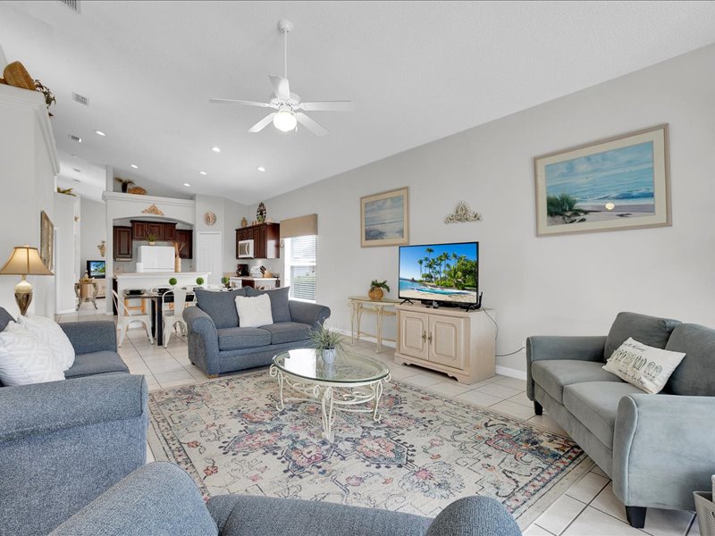 Living room w/ couches, chair & flat screen TV