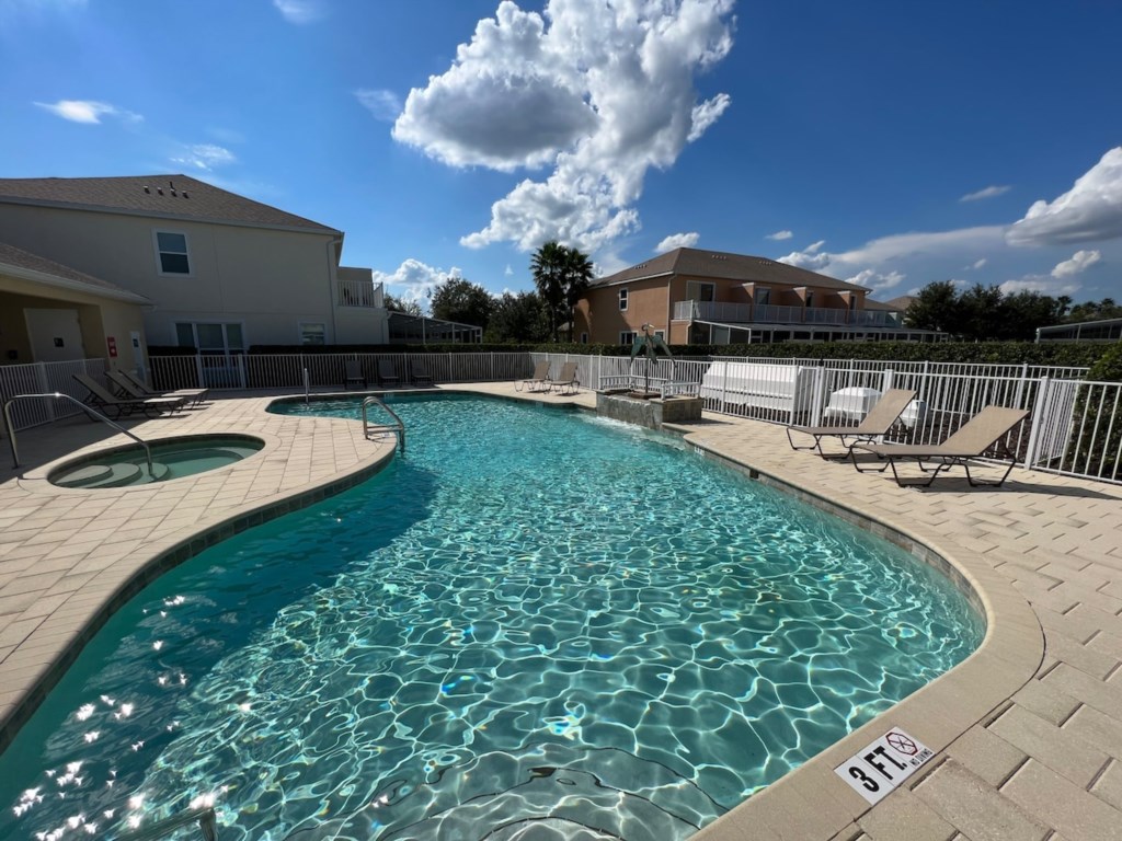 Large Communal Pool & Hot Tub: Includes lounge chairs for relaxing and soaking up the sun.