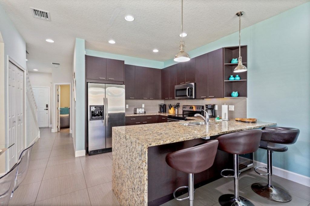 Stylish kitchen with granite countertops and bar seating for two.