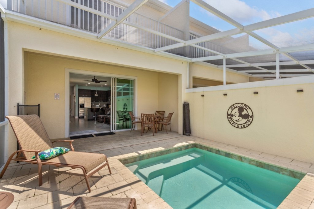 Private splash pool with screened patio, perfect for relaxing in the sun.