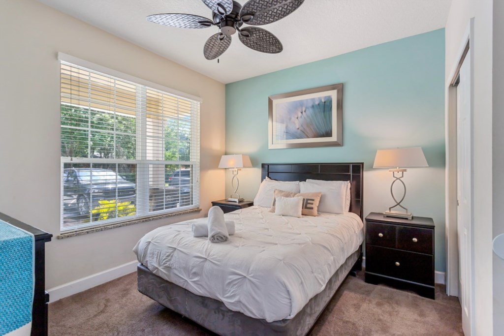 Cozy master bedroom with plush bedding and natural light for a restful sleep.