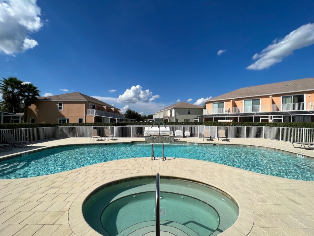Large Communal Pool & Hot Tub: Includes lounge chairs for relaxing and soaking up the sun.