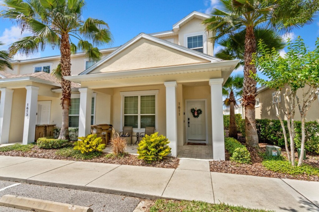Charming home exterior with palm trees, welcoming you to your stay.