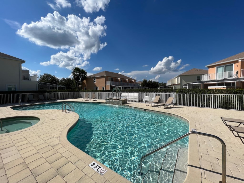 Community pool with lounge area, ideal for sunny days and family fun.