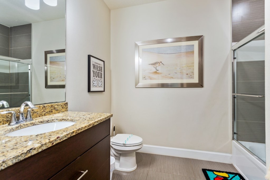 Convenient half-bathroom with modern fixtures and coastal decor.