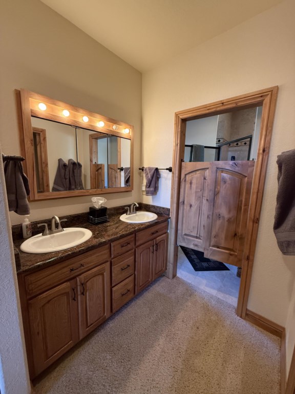 Ensuite bathroom with walk in shower, large tub, walk in closet, and double sinks.