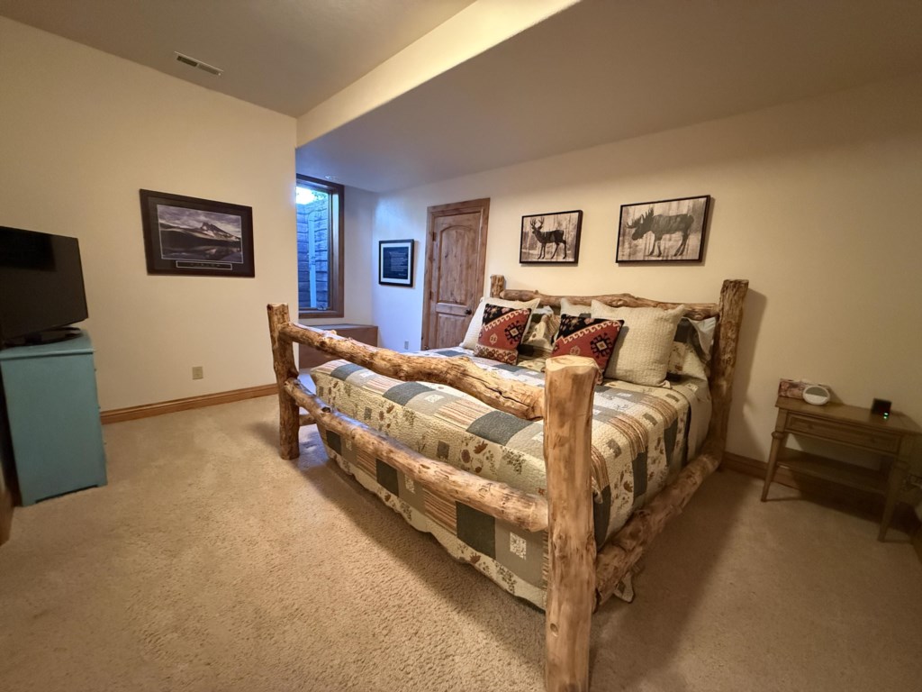 Basement bedroom with King bed, tv, and Jack and Jill bathroom