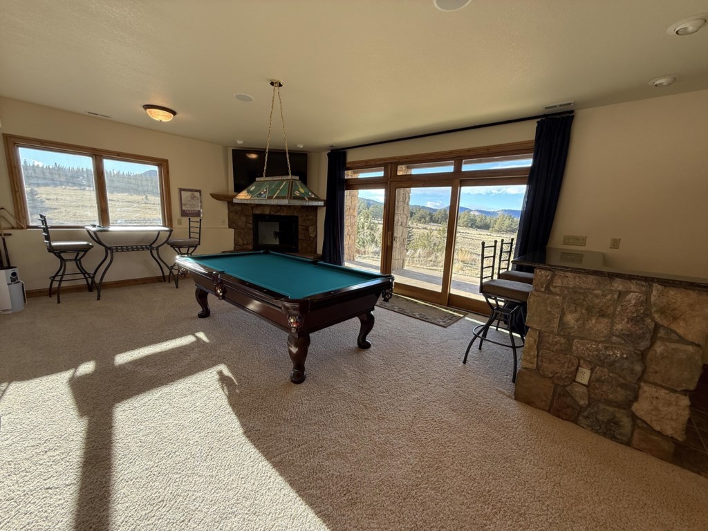 Pool table and large screen tv perfect for watching your favorite team while looking out on Eleven Mile Reservoir