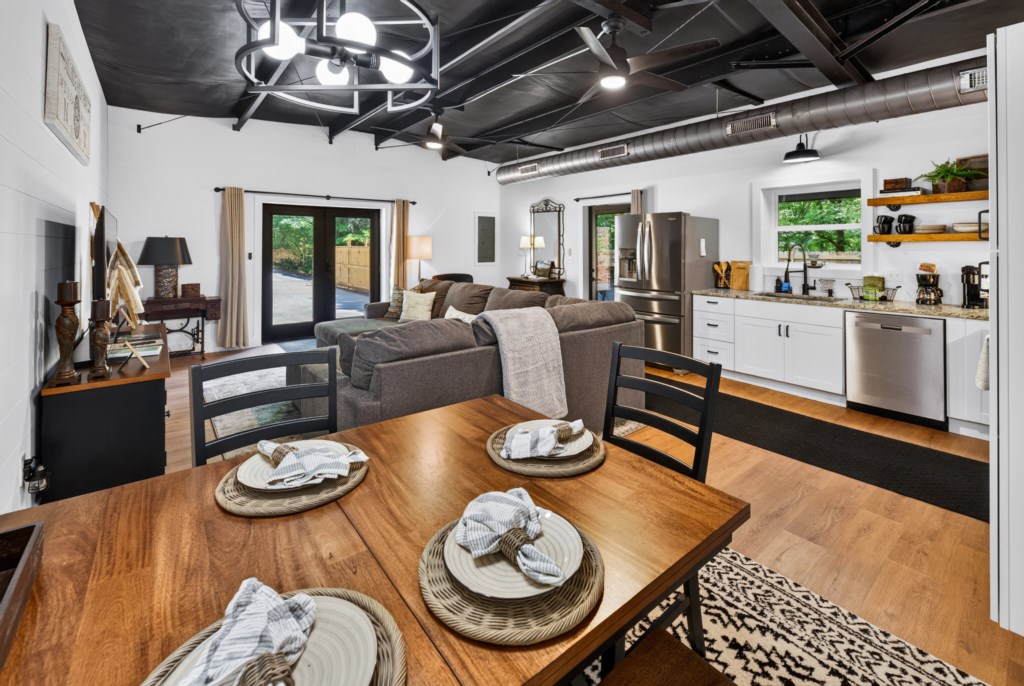 Open-concept living area with modern kitchen and cozy dining space, ideal for entertaining.
