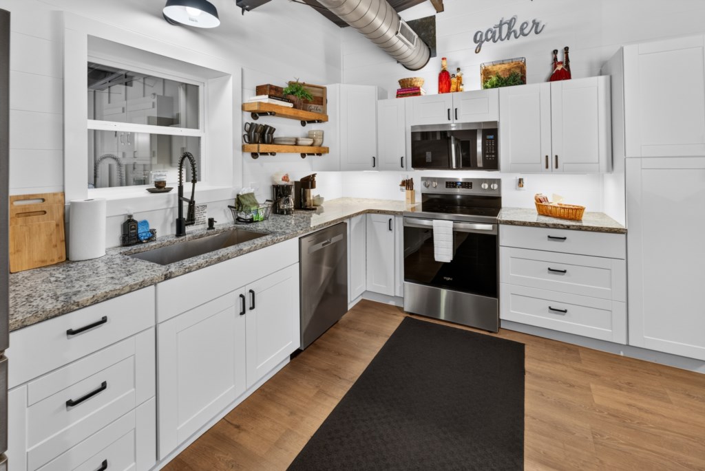 Modern kitchen with stainless steel appliances and ample counter space for cooking.