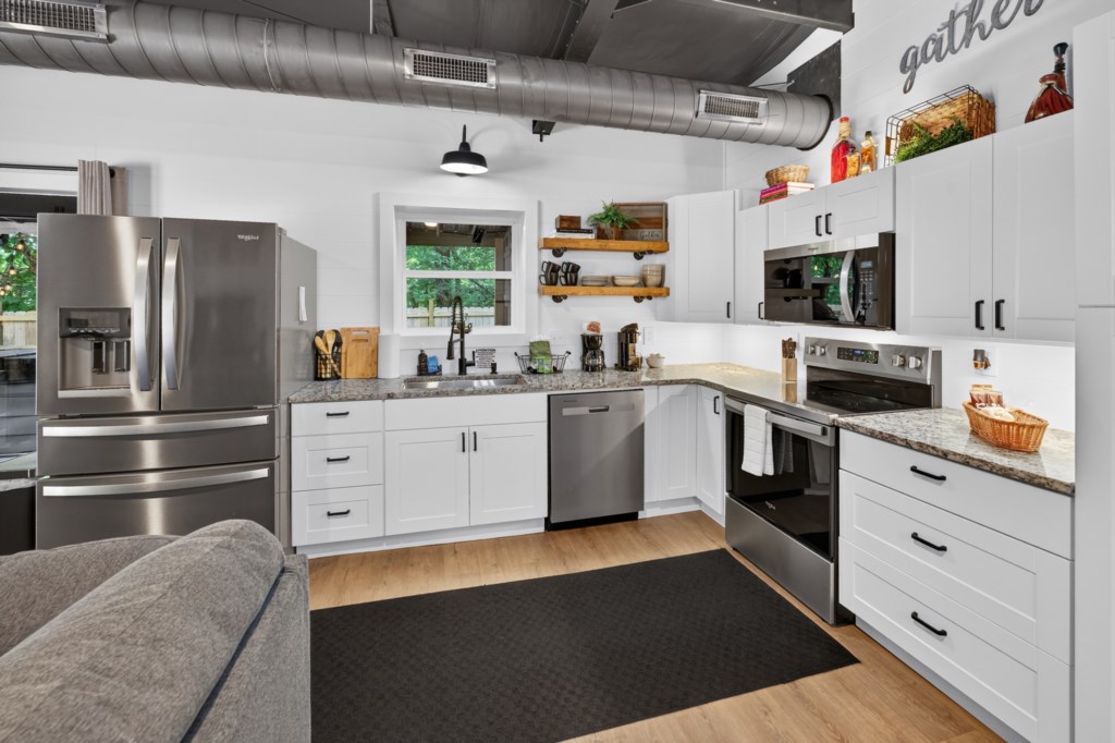 Modern kitchen with stainless steel appliances and ample counter space for cooking enthusiasts.
