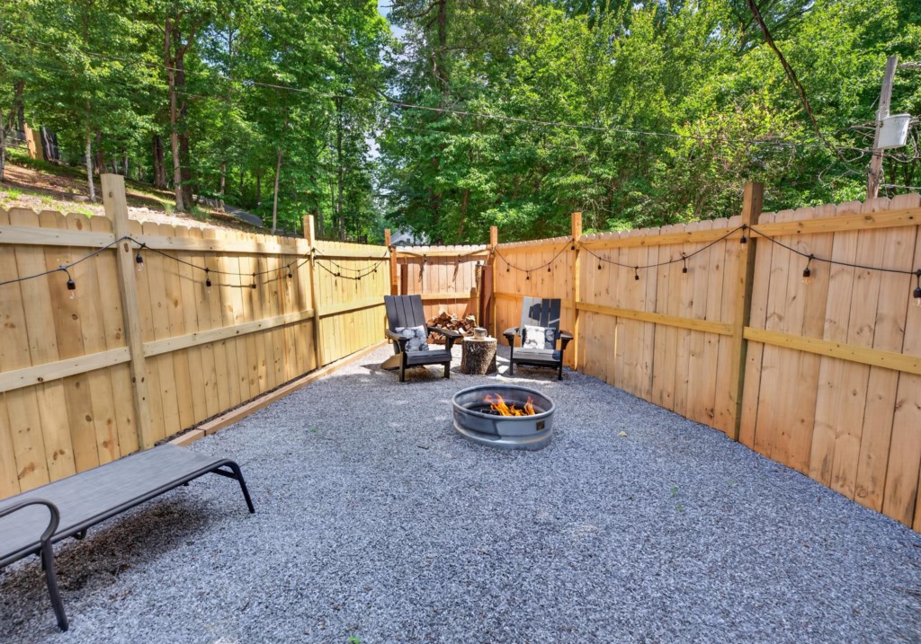 Cozy outdoor firepit area with string lights, perfect for evening gatherings.