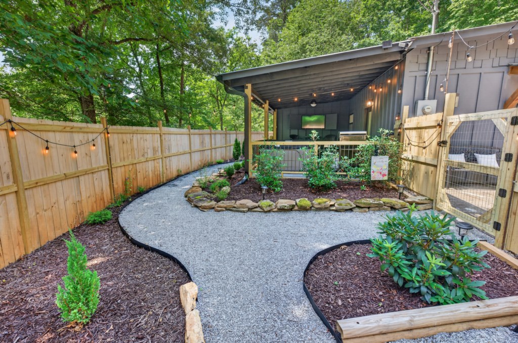 Charming outdoor patio with garden path and cozy seating area for relaxing evenings.