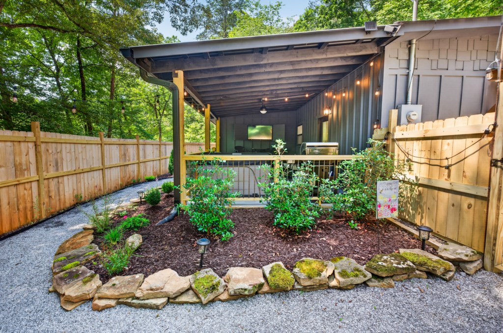 Cozy covered patio with garden views, perfect for relaxing in the fresh air.