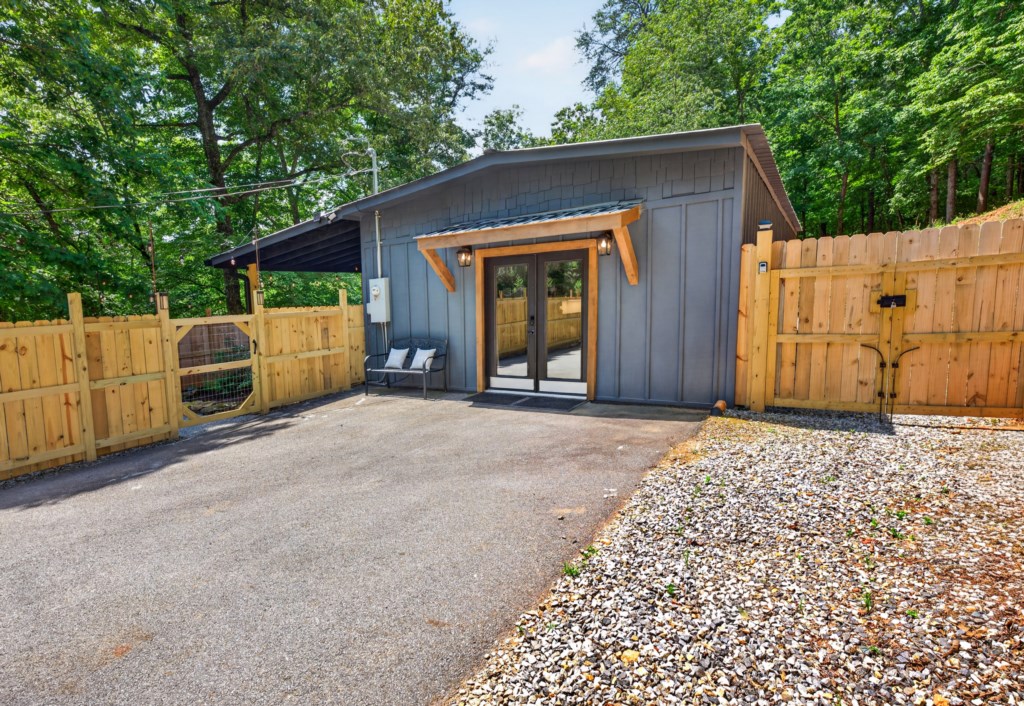 Charming cabin with private entrance surrounded by lush greenery.