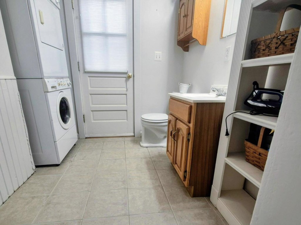 1/2 bath shares space with a full size washer and dryer
