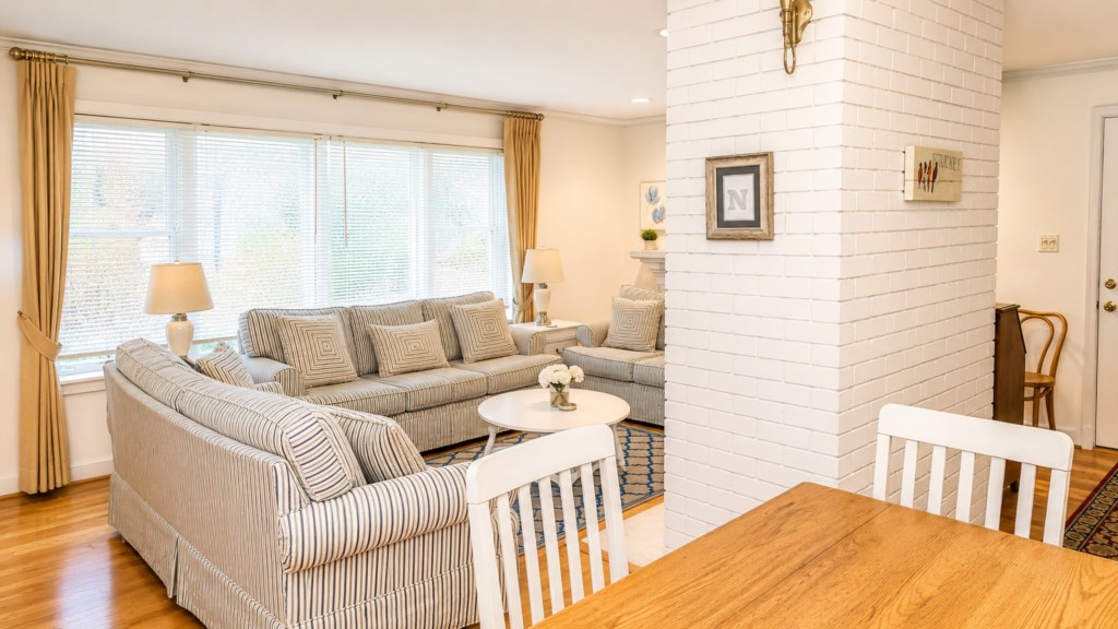 Open living and dining area with hardwood floors, ample seating and natural light.
