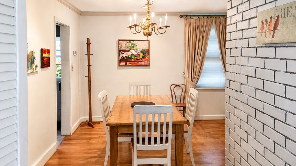 Dining room with seating for six, hardwood floors and warm natural light


