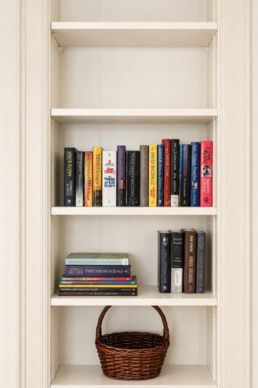 Built-in bookshelves with a small collection of books and guest reading material.