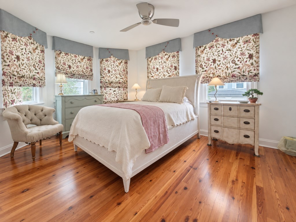 Bright, comfortable bedroom with beautiful hardwood floors and plenty of natural light.
