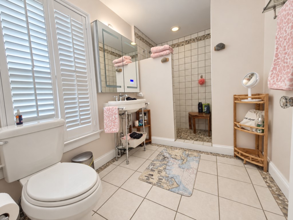 Full bath with walk in shower is attached to the primary suite