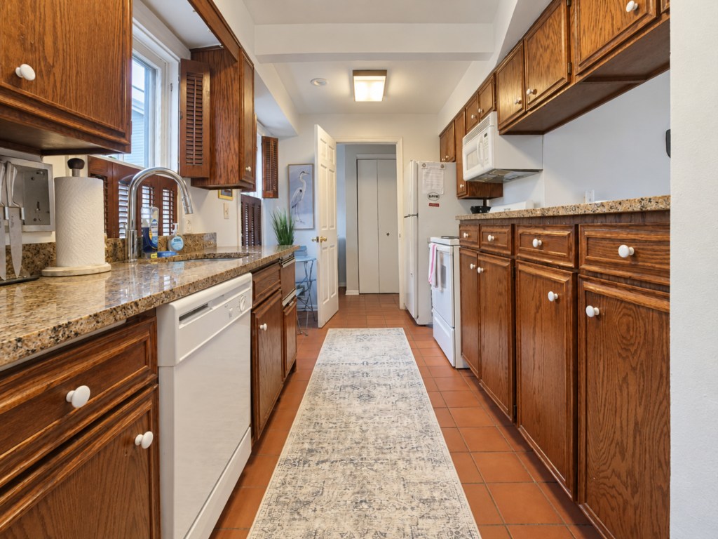 Galley kitchen with generous cabinet and counter space.