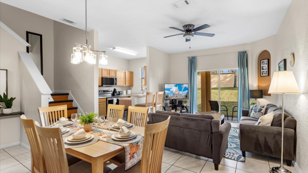 Living Room
Welcoming living space with two comfortable sofas, vibrant décor, flat-screen TV, and sliding glass door.