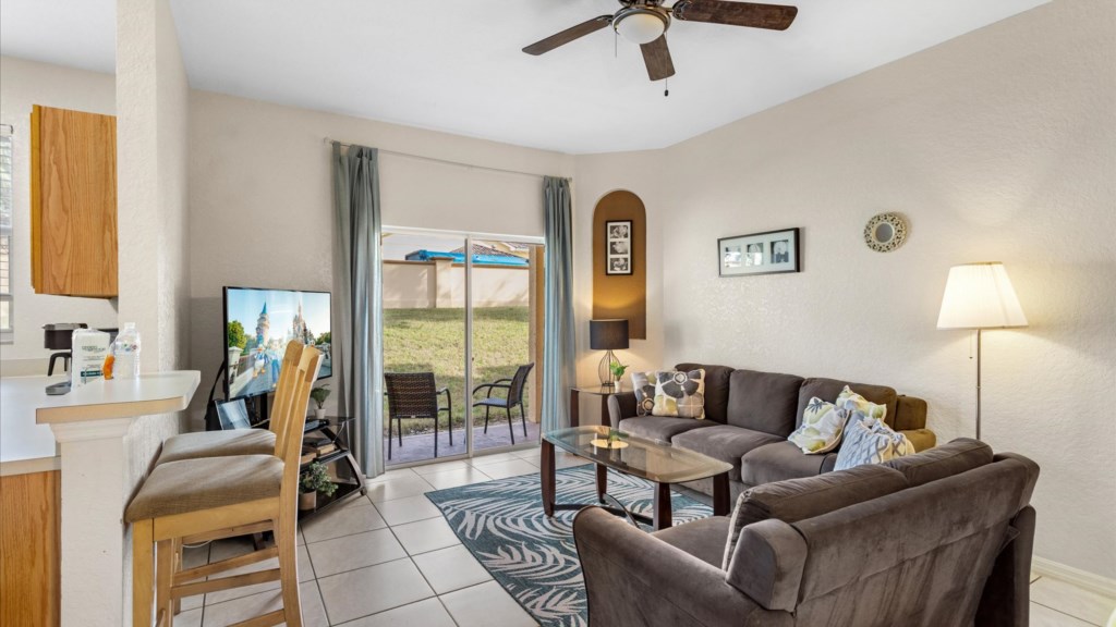 Living Room
Welcoming living space with two comfortable sofas, vibrant décor, flat-screen TV, and sliding glass door.