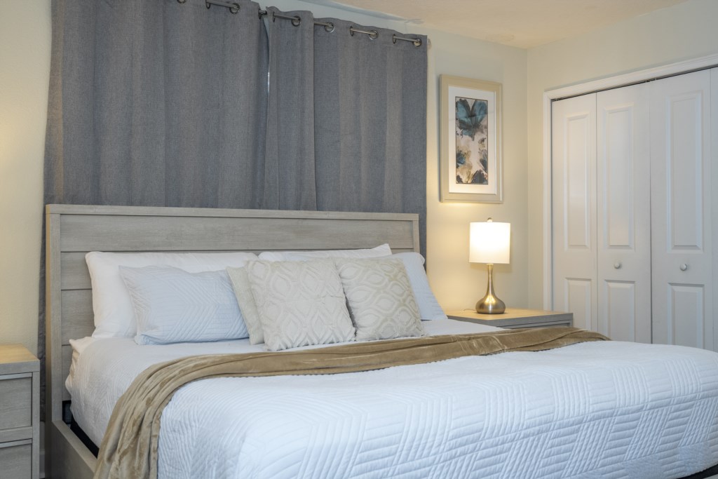 Master bedroom with king size bed and flat screen TV