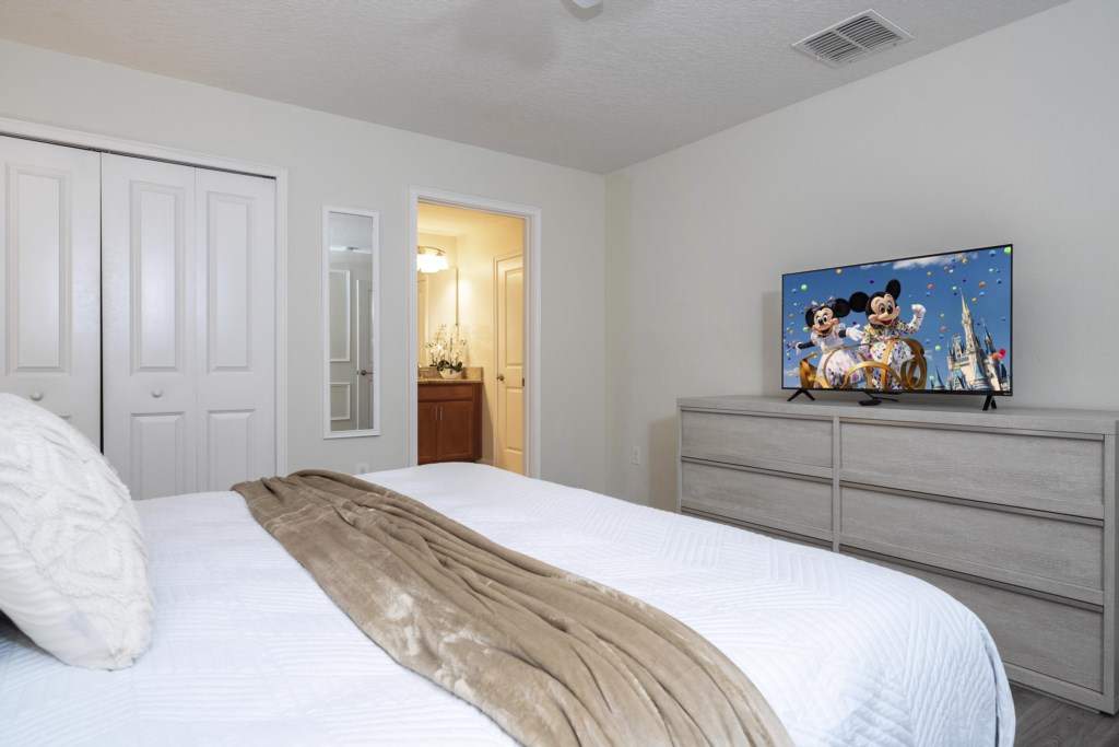Master bedroom with king size bed and flat screen TV
