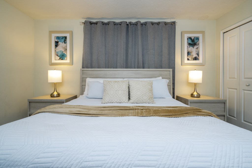 Master bedroom with king size bed and flat screen TV