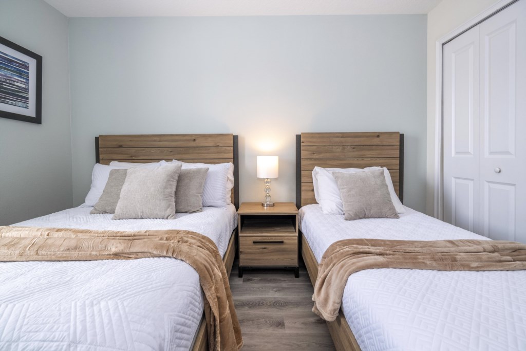 Guest bedroom w/ full + twin beds and flat screen TV