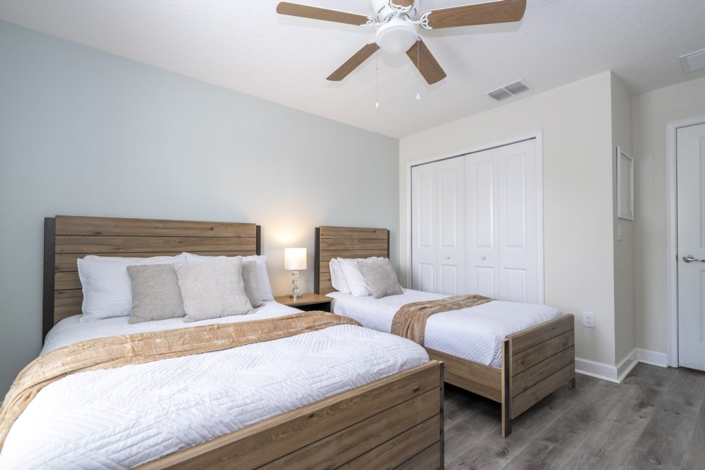 Guest bedroom w/ full + twin beds and flat screen TV