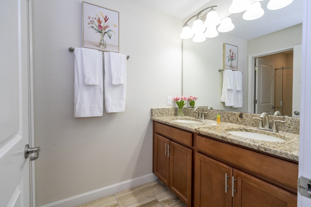 Shared bathroom w/ walk in shower and double sinks