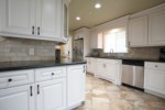 Partial Open-concept Custom Kitchen
The kitchen has granite countertops and custom panel cabinetry with stainless steel 