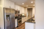 Open Concept Custom Kitchen with Stainless Steel Appliances