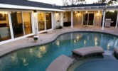 Stunning In-ground Pool and Jacuzzi with Waterfall Features Evening